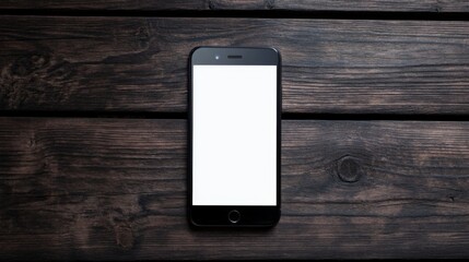 Black cell phone with a white screen sits on a wooden table