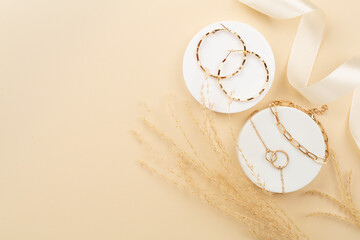 Elegant golden jewelry with decoration on color background, top view