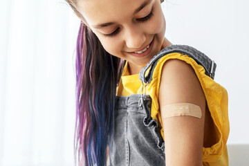 Healthcare And Inoculation Concept. Portrait Of Smiling Teen Patient Showing Vaccinated Arm With Plaster On Shoulder After Coronavirus Vaccination, Looking At Hand. Antiviral Vaccine, Banner, Panorama