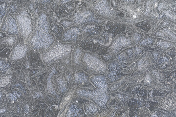 pattern frozen into surface of ice on pond