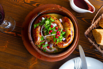 Georgian homemade sausages Kupaty, traditional caucasian dish served with cilantro and pomegranate