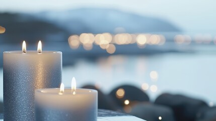 Lit candles illuminate a table beside calm water, creating a serene and inviting atmosphere perfect for relaxation or gatherings.