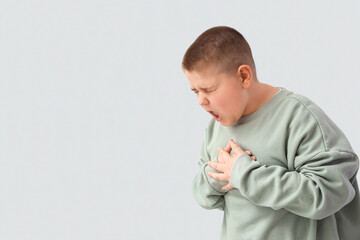Sick little boy on grey background