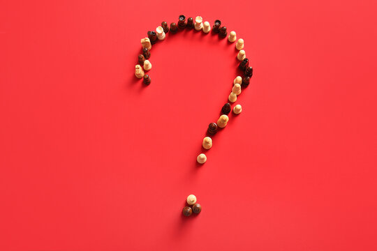 Question mark made of chess pieces on red background