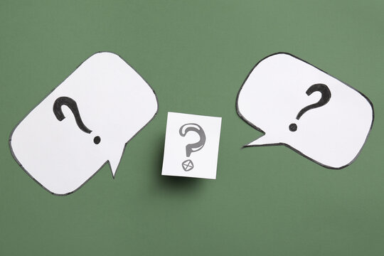 Speech bubbles with question marks on green background