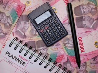 Financial Planning Setup with Calculator, Money, Planner book and Pen