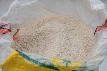 Rice in sacks for sale in a market. Shallow depth of field, focus on the rice in the foreground sack.