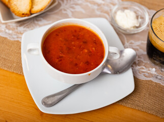 Borsch, beetroot hot soup and bread on the table in a cafe