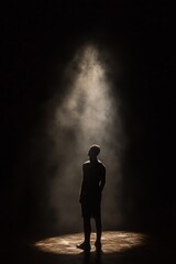 Figure of a man in a spotlight