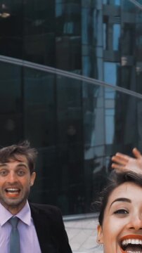 Slow motion. 3 attractive positive happy exulting of lucky win Businesspeople jump high in air with smiling wite teeth. Glass contemporary building dackground. Middle Rapid shoot. Sunrise. Vertical