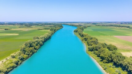 Fototapeta premium Aerial view of serene river flowing through lush agricultural landscape