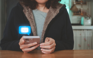 Woman using smartphone to check and read new email notification alert. Inbox electronic mail receive electronic message campaign. Digital marketing business online communication technology concept.