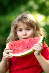 Fun Kid with watermelon. Funny kid eating watermelon outdoors in summer park. Child, baby, healthy food. Child eating watermelon in the garden. Kids eat fruit outdoors. Kid enjoying watermelon.