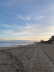Beach landscape with clouds and yellow hues in the sky