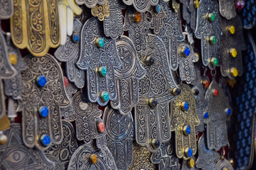 Hands of Fatima in Metal hanging from a street stall in the Marrakech souk