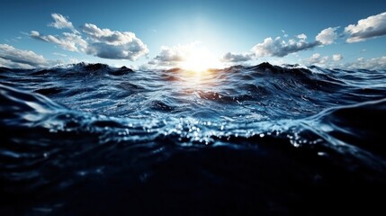 Fototapeta premium A serene ocean view at sunset with waves reflecting light and clouds above.