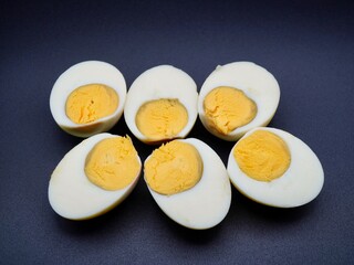 Boiled chicken egg slices isolated on a black background