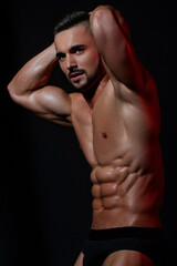 Fototapeta premium Handsome muscular man. Sexy body of fit male sexy model. Beauty man with perfect muscular body. Hot naked young middle eastern guy enjoying his muscular body. Shirtless, portrait and sexy man.