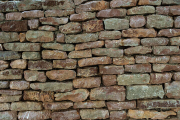 Close-up of a rustic dry stone wall built without mortar in a Mediterranean landscape