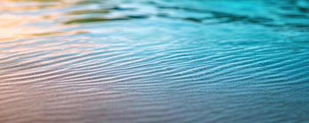 Concept of coastal relaxation with resort peace. A serene water surface reflecting soft hues of blue and orange, showcasing gentle ripples and a tranquil ambiance.