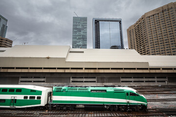 Selective blur on A green-striped suburban train rushing towards toronto train station in ontario,...