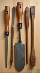 A close up of a wooden table with a knife, spatula, and other tools