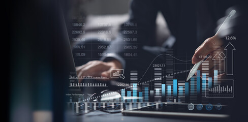 Businessman using digital tablet analyzing sales data and financial growth graph chart report....