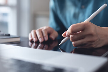 Close up, business woman hand with stylus pen signing e-document on digital tablet via mobile app...