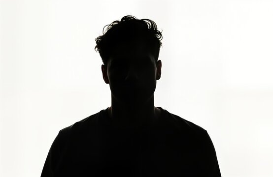Mysterious male silhouette against white background. Unknown person dark figure. Serious expression. Suitable for profile portraits social media avatars. Silhouette ideal for variety of themes like