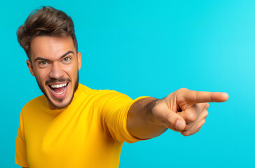 Fototapeta premium Excited man pointing enthusiastically on a blue background