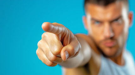 Man pointing with determination against blue background