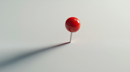 A red pushpin is stuck on a white paper