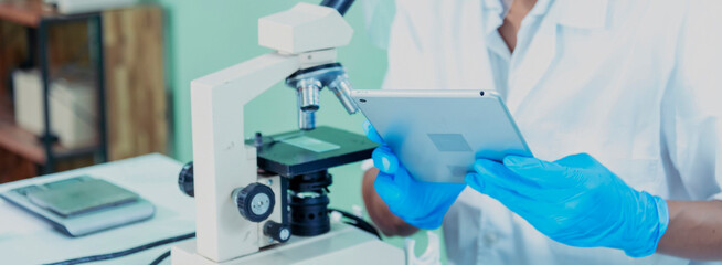 Banner Scientist man look Microscope research in science laboratory. Banner Asian scientist use...