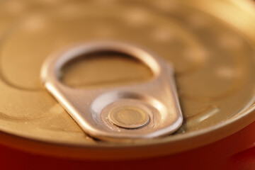 Close-up of a can tab ready to be opened, revealing metallic details and texture