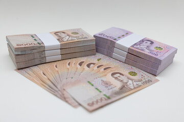 Banknote thai baht, paper bank, price of one thousand, stacked sets isolated on white background. 1000, 500 Bath bank note for shopping, paying bills, taxes, debt, insurance, financial, investment.