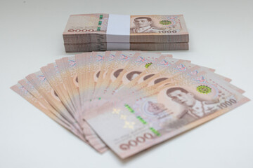 Banknote thai baht, paper bank, price of one thousand, stacked sets isolated on white background. 1000, 500 Bath bank note for shopping, paying bills, taxes, debt, insurance, financial, investment.