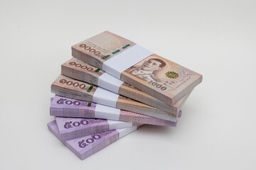 Banknote thai baht, paper bank, price of one thousand, stacked sets isolated on white background. 1000, 500 Bath bank note for shopping, paying bills, taxes, debt, insurance, financial, investment.