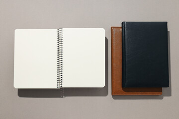 Notebooks of different colors lie on a light background