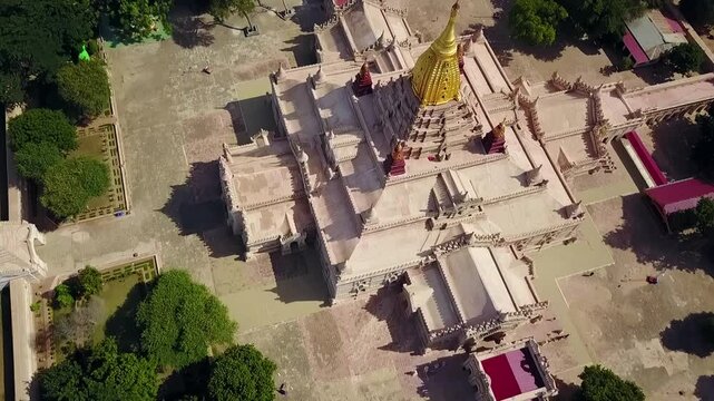 A stunning bird's-eye aerial view over the White Temple at Ananda Temple in Bagan, Myanmar, highlighting the golden Sertok. Perfect for showcasing the temple&rsquo;s architecture and historical beauty.