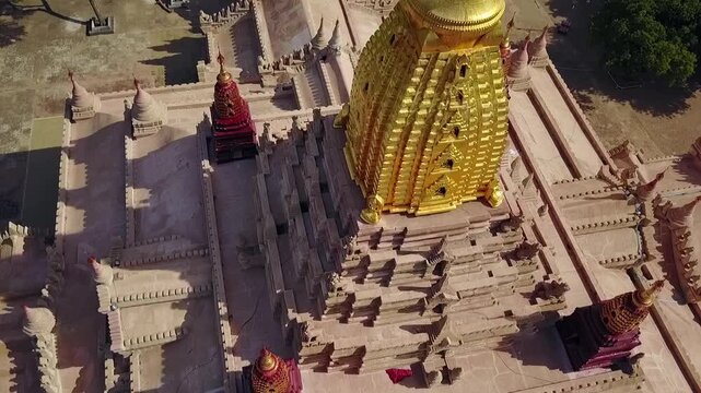 A captivating aerial point of interest shot around the White Temple and Ananda Temple in Bagan, Myanmar. Showcases the grandeur of these iconic ancient landmarks surrounded by lush landscapes.