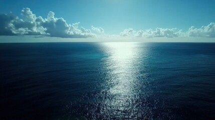 Serene Ocean View with Glimmering Water and Cloudy Sky Above