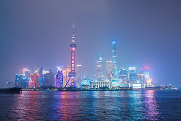 Cityscape view of Shanghai city at night. Skyscraper of Lujiazui in Pudong, view from The Bund of Shanghai, China. landmark and popular for tourism attractions. Travel and Vacation concept