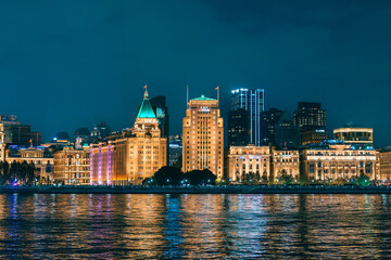Fototapeta premium Cityscape view of Shanghai city at night. Skyscraper of the Bund, view from Lujiazui in Pudong of Shanghai, China. landmark and popular for tourism attractions. Travel and Vacation concept