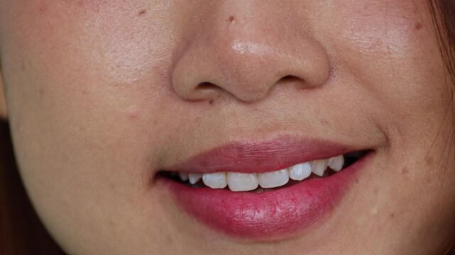Healthy asian woman with beautiful smile, pink red lips smiling gently, charming and beautiful face happy : Video was shot in a room.