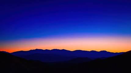Fototapeta premium Serene Sunset Silhouette Over Majestic Mountains