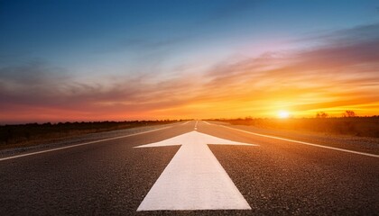 Asphalt road at sunset with a large white arrow pointing forward.