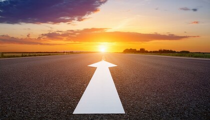 Asphalt road leading towards a vibrant sunset.