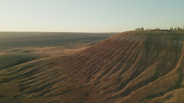Red ravine erosion showing environmental damage at sunset