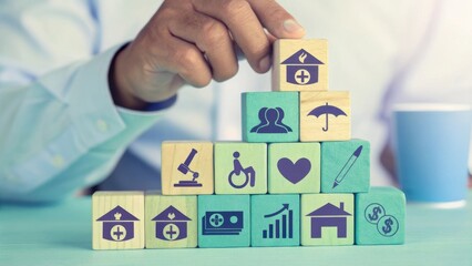 A hand is stacking colorful blocks with health and wellness icons, symbolizing a structured approach to healthcare.