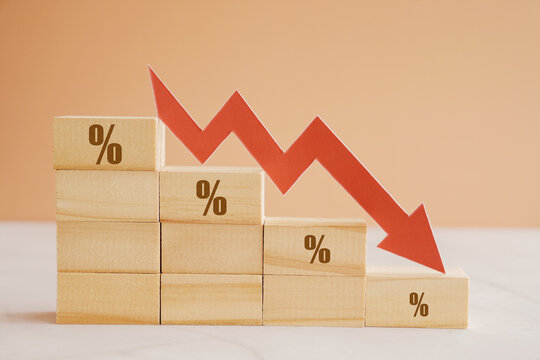 Wooden blocks with percentage sign and down arrow, financial recession crisis, interest rate fall, economic depression concept